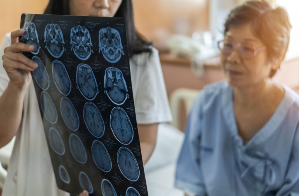 A doctor shows a patient images of their brain from a scan to explain a dementia diagnosis and what that means for them