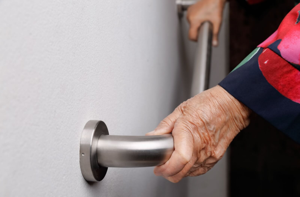 Someone holds onto a handrail to reduce the risk of falling.
