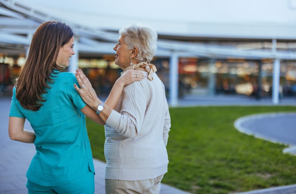 A caregiver embraces a senior resident at a senior living community
